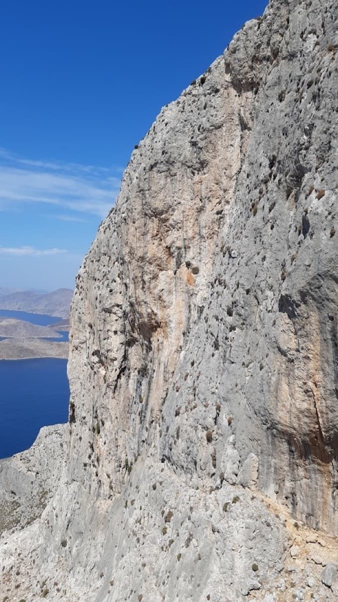 Side-on view along the cliff, titled 'Olympic Wall' by the photographer, who notes that Abert Project climbs the grey slabs (September 2021).