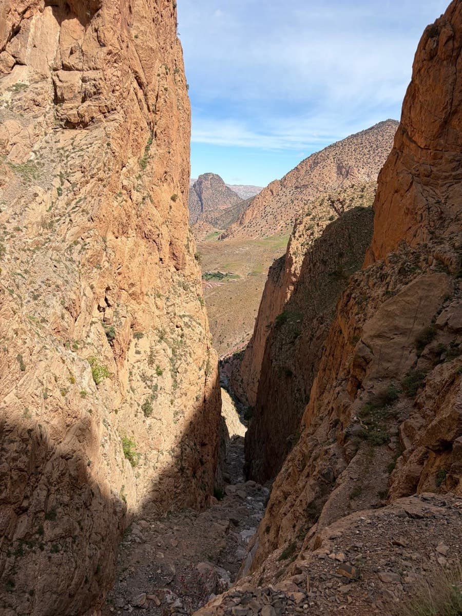 Inside the gully between the Oujdad and the Taoujdad, looking back down towards the Taghia valley: the approach climbs this stony bed before the ledges lead off left.