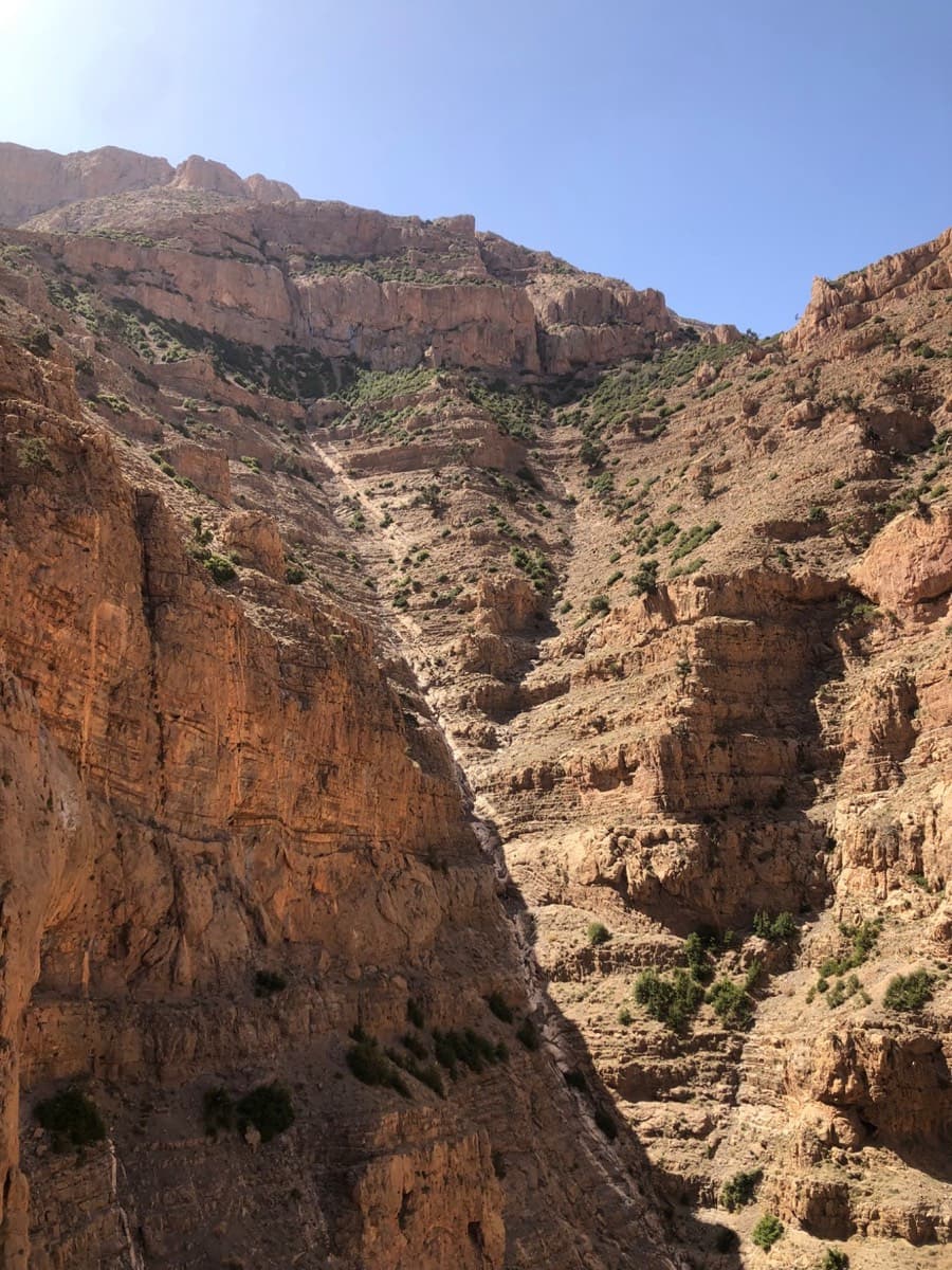 The gully that separates the Oujdad from the Taoujdad, seen from high on the west face: the approach comes up its bed, and it is also the way down.