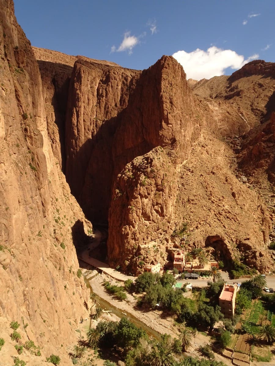 The gorge entrance from above: the road, the river and the hotels at the mouth of the gorge, with the walls of the entrance sectors rising straight from the river bank.