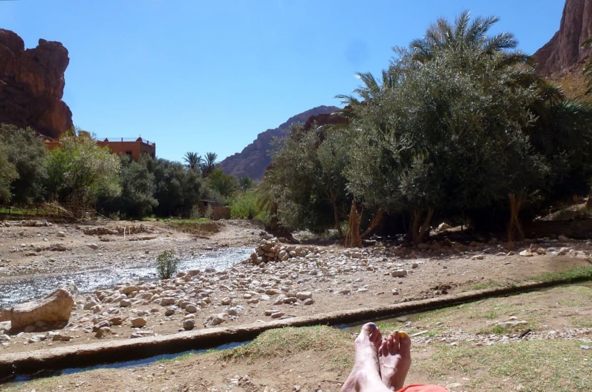 Looking back from the foot of the route (February 2018): the stream you cross from the guesthouses, with the low concrete wall of the irrigation channel in the foreground.