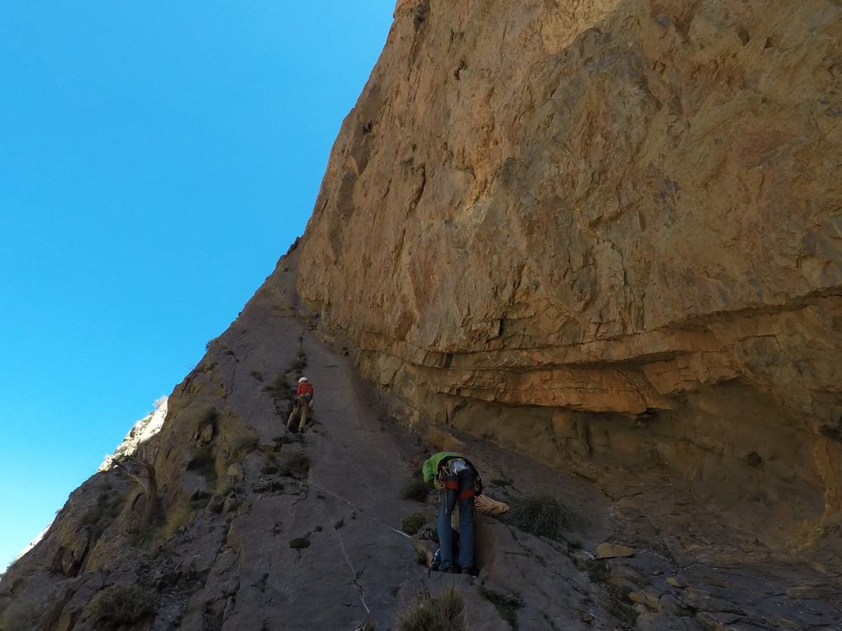 At the start: the party sets off up the slabby ramp under the steep west face.