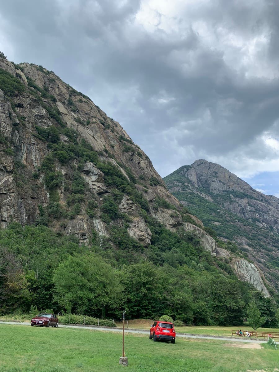 The Paretone, with the Pilier Lomasti behind, seen from the grass parking area on the valley floor at Arnad (June 2022). That party found the lower roadside car park closed and parked up by the osteria.