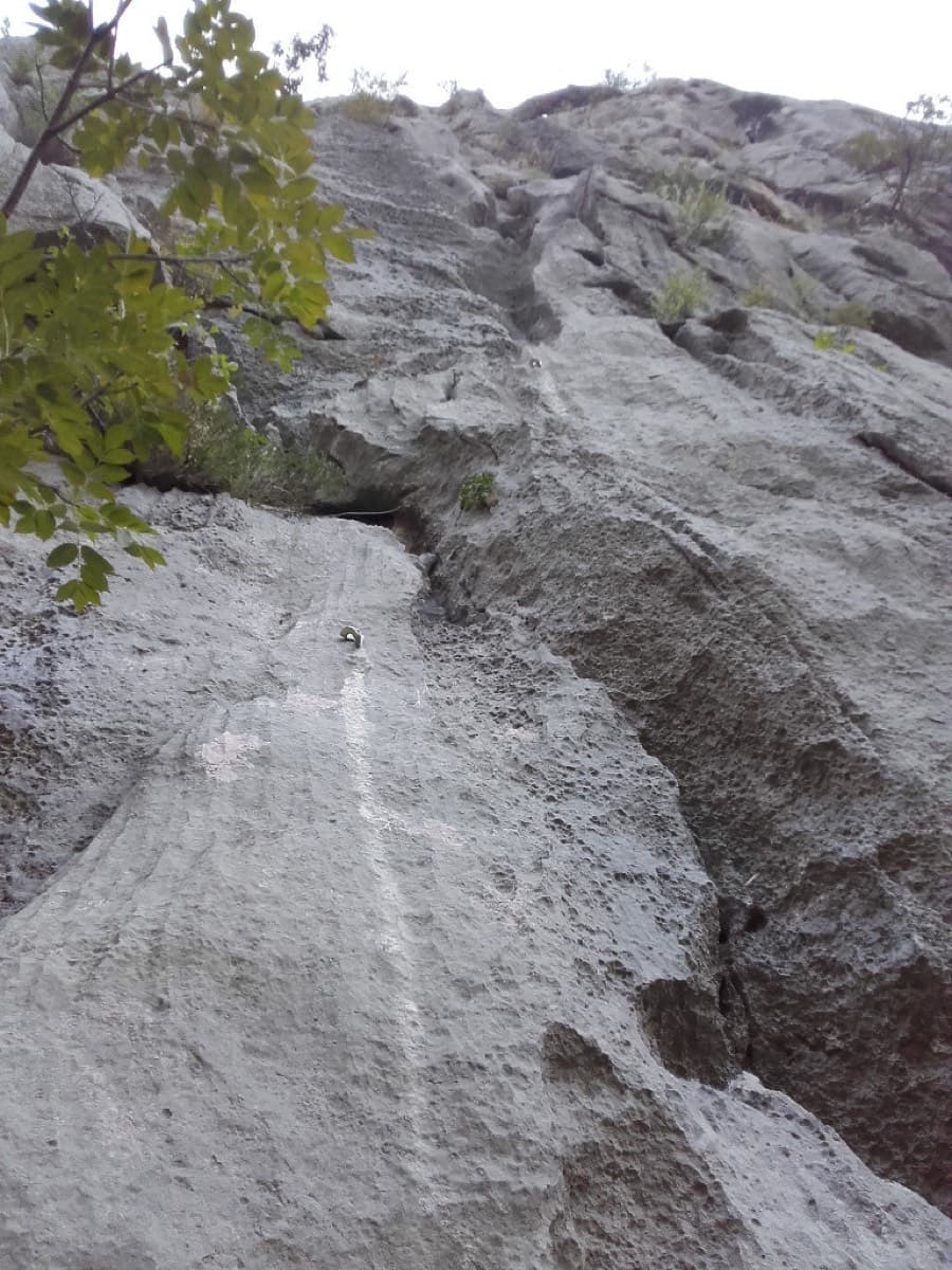 Looking up from the start of the route (photographer's title: "at the start of the route"): a bolt is visible on the pale streak in the middle of the slab.