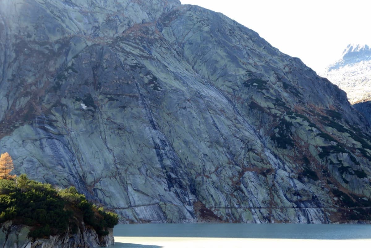 The Seeplatten above the lake, with the path along their base. The photographer notes that the route climbs to the right of the waterfall.