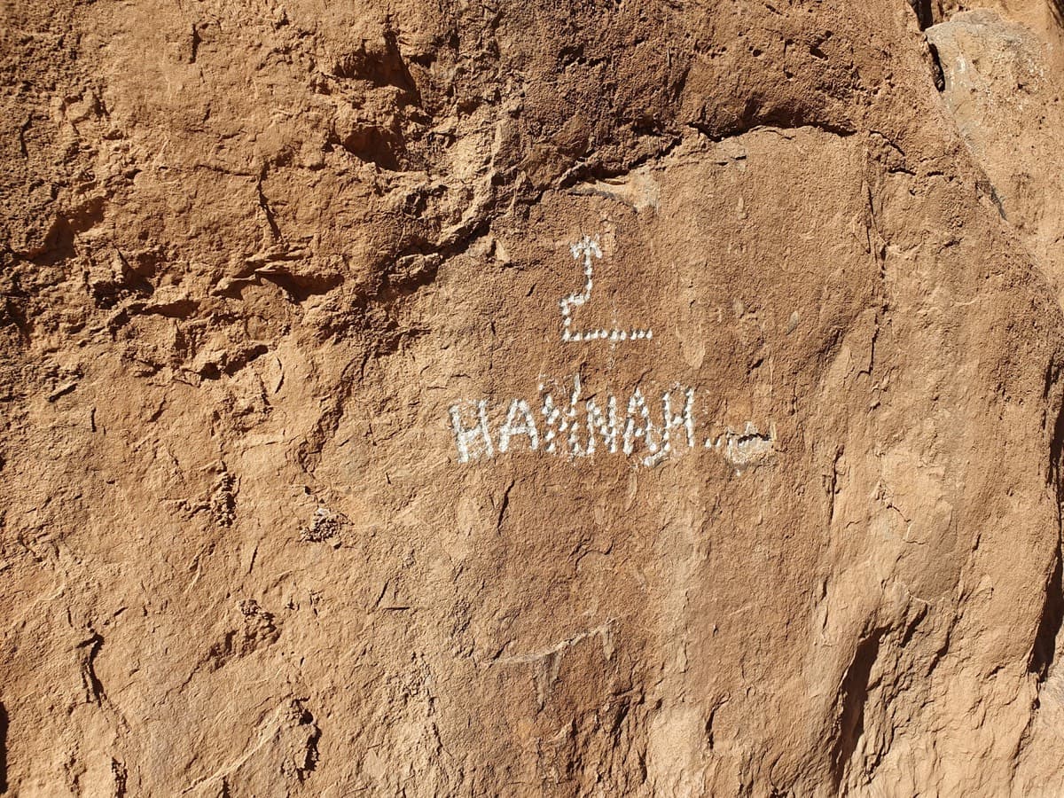 The name 'HANNAH' and an arrow drilled into the rock at the foot of pitch 1.