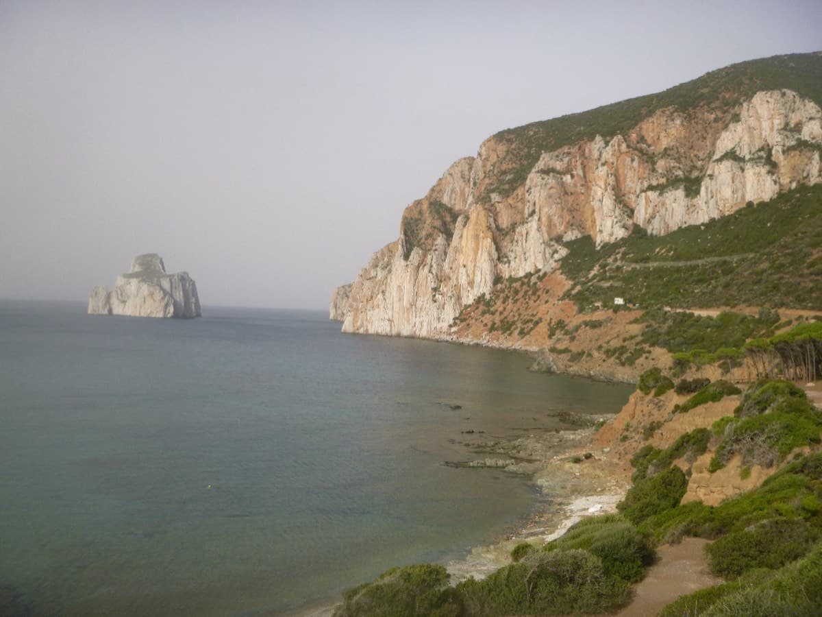 The Masua sea cliffs and the Pan di Zucchero stack seen from the Masua side, the direction you arrive from.