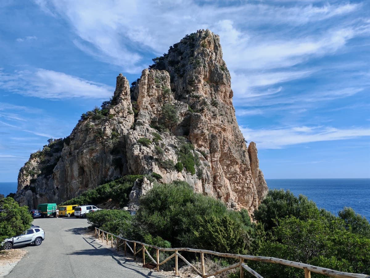 The end of the road at Pedra Longa, with cars parked below the stack.