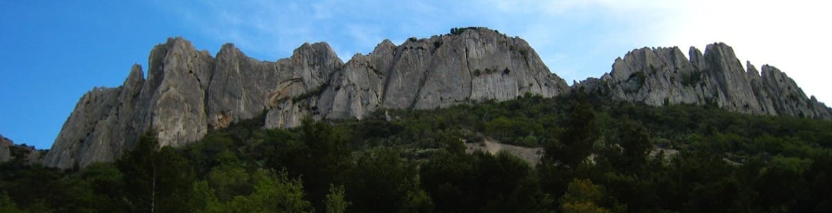 The western part of the north face of the Chaîne de Gigondas, seen from below on the north side. The approach path stays under this side of the crest until the start near the west end.