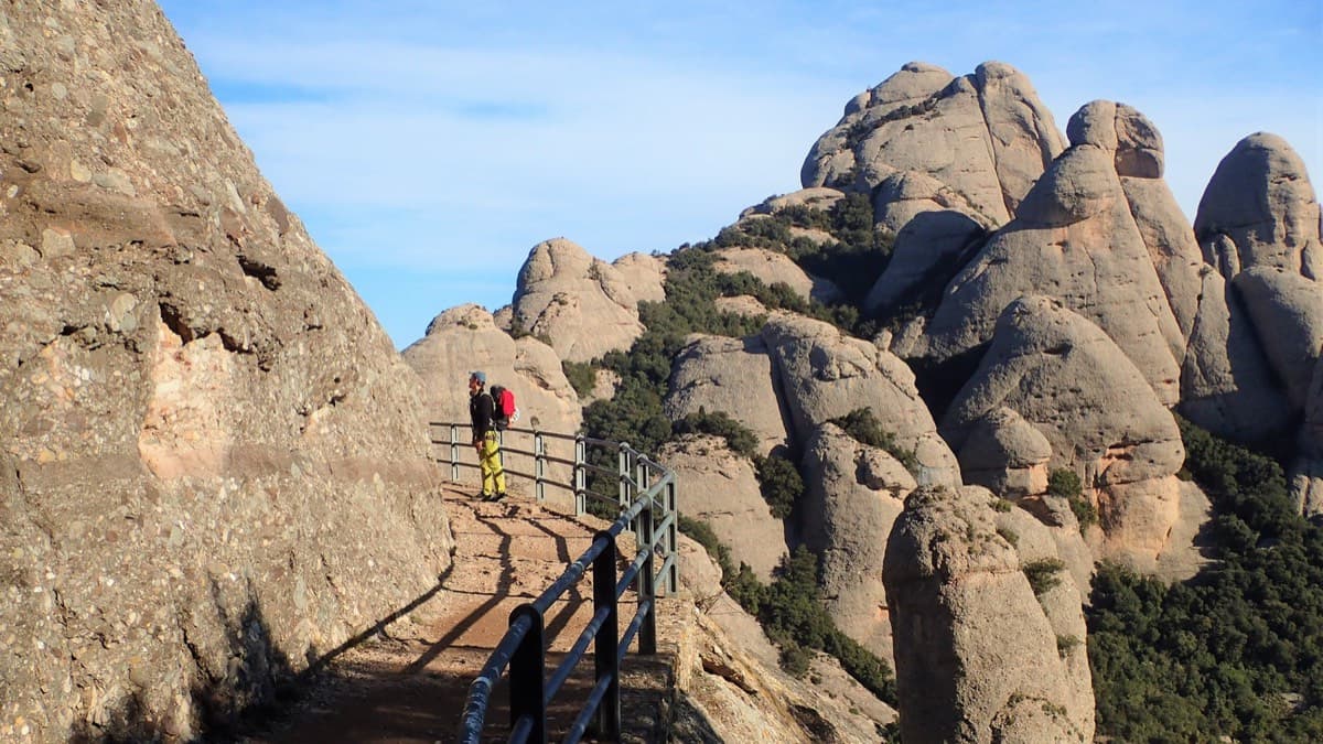 The railed Sant Jeroni path at the start of the route, where it is cut into the rock at the foot of the Gorra Frígia.