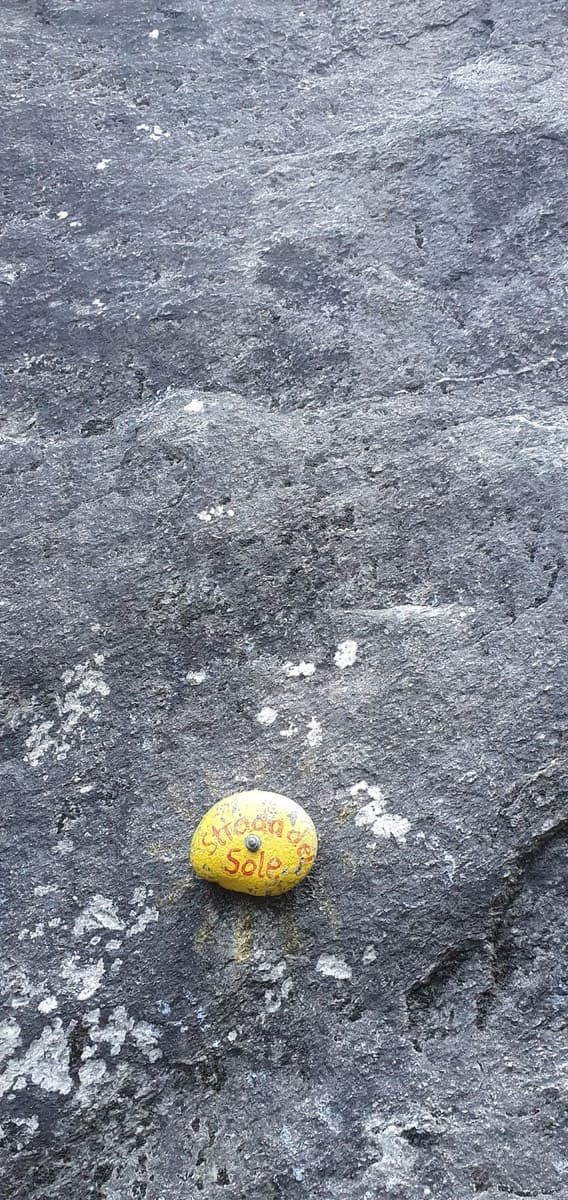 The painted stone that marks the start of Strada del Sole at the foot of the Nösslachwand
