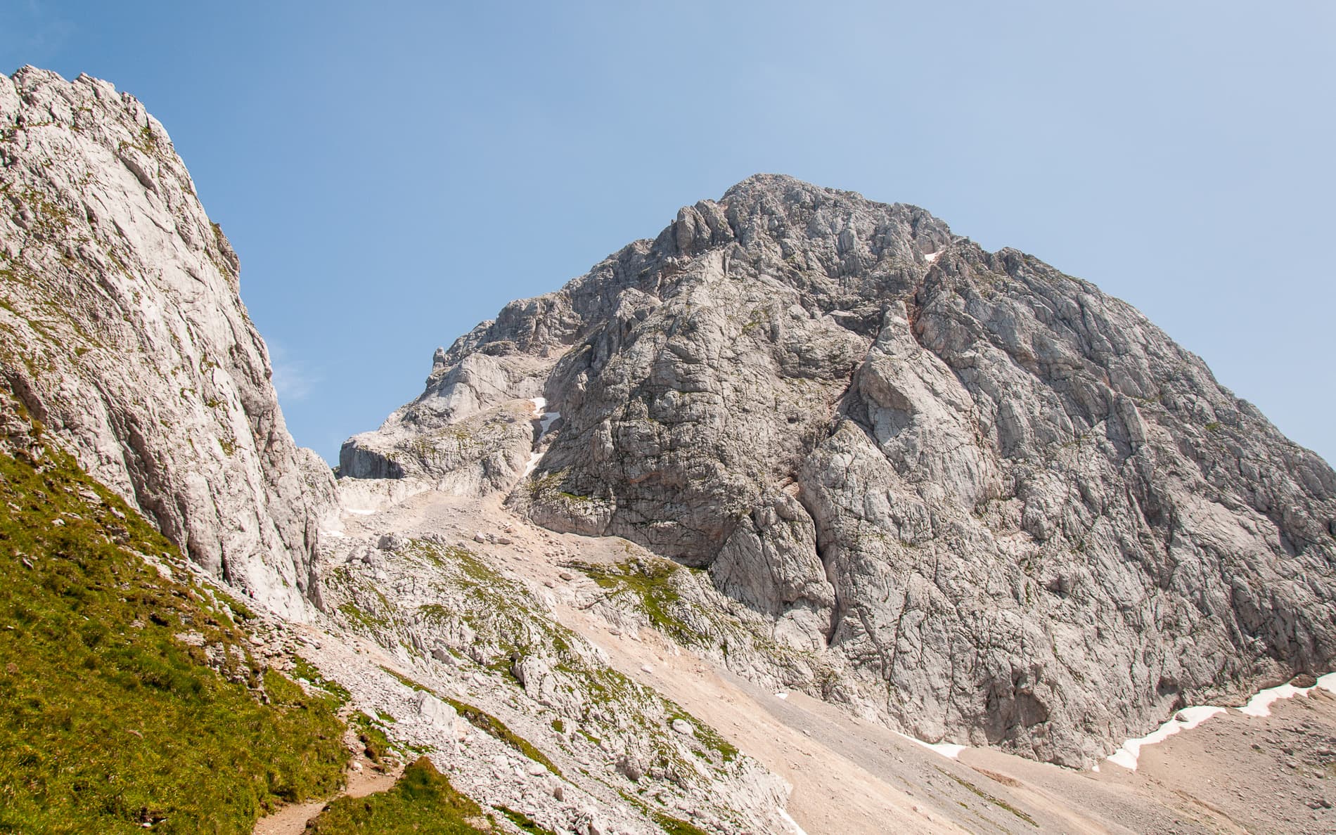 Mangart seen from the path above the Mangart saddle: the pale limestone dome that Briljantina climbs, above its scree apron.