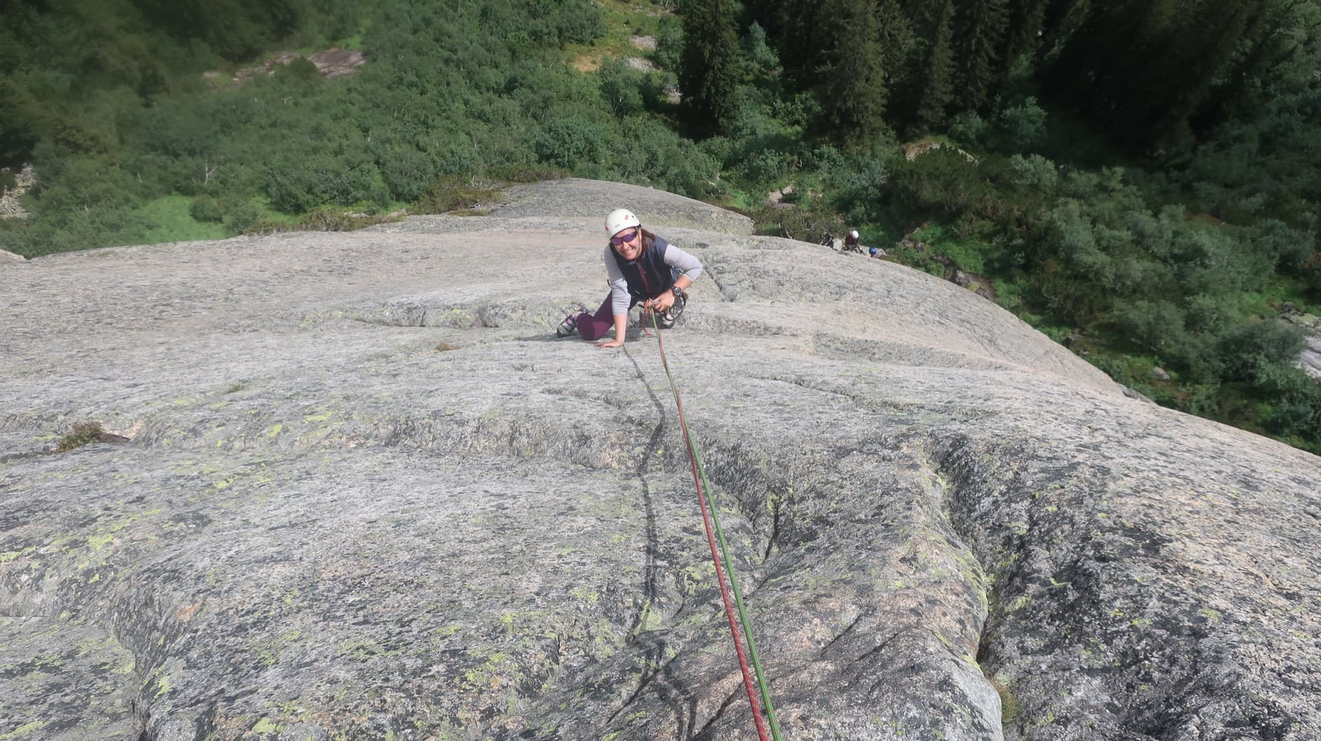 Topping out on the lichen-streaked granite slab of Bügeleisen above the forest at Handegg.