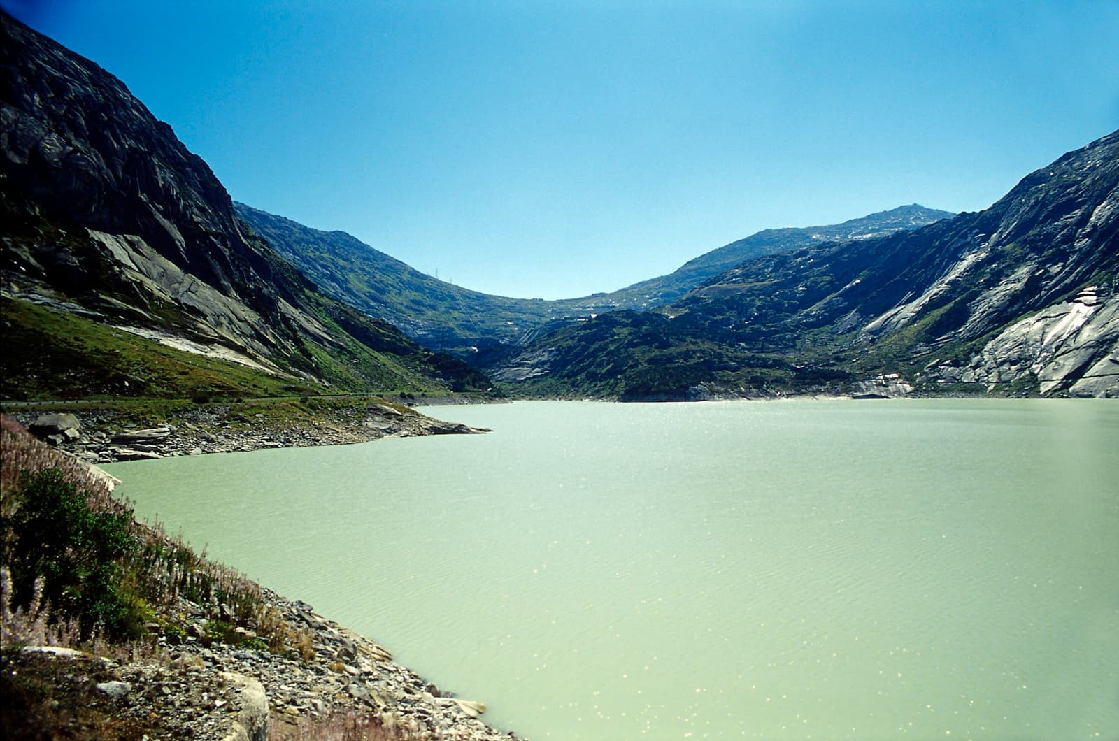 The Räterichsbodensee seen from above its dam; the Seeplatten are the slabs along its western shore.