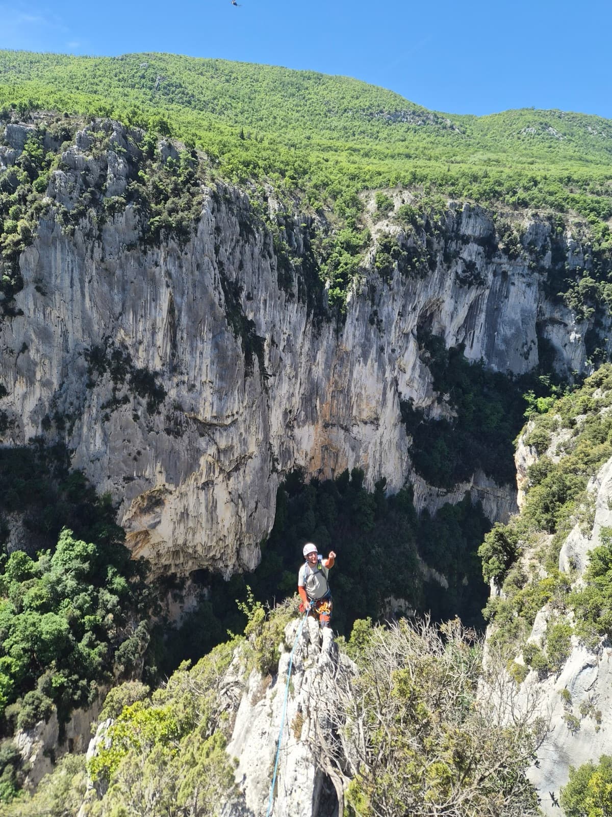 A climber on the crest of the Arête de l'Herbetto, with the main Imbut wall behind.
