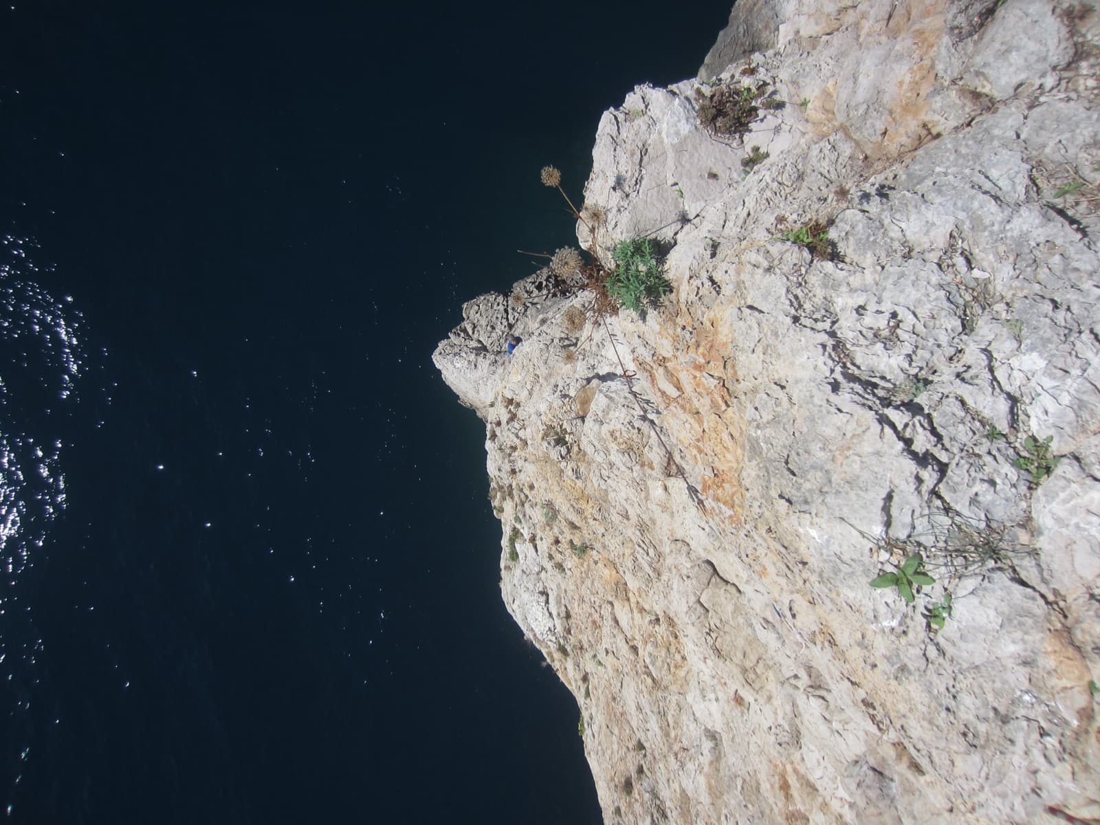 Looking straight down to the sea from the first belay of La Croce del Sud, Montagna Spaccata.