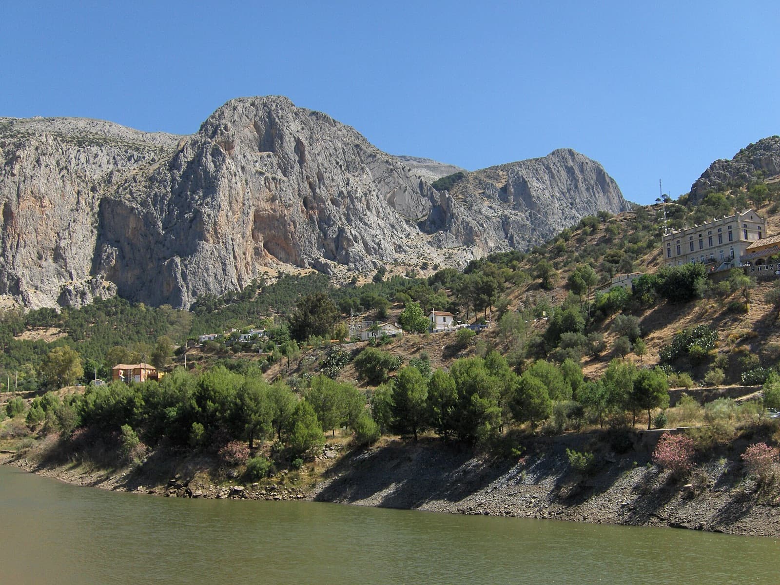 A wider view of the Frontales cliffs from the south shore of the reservoir at El Chorro.