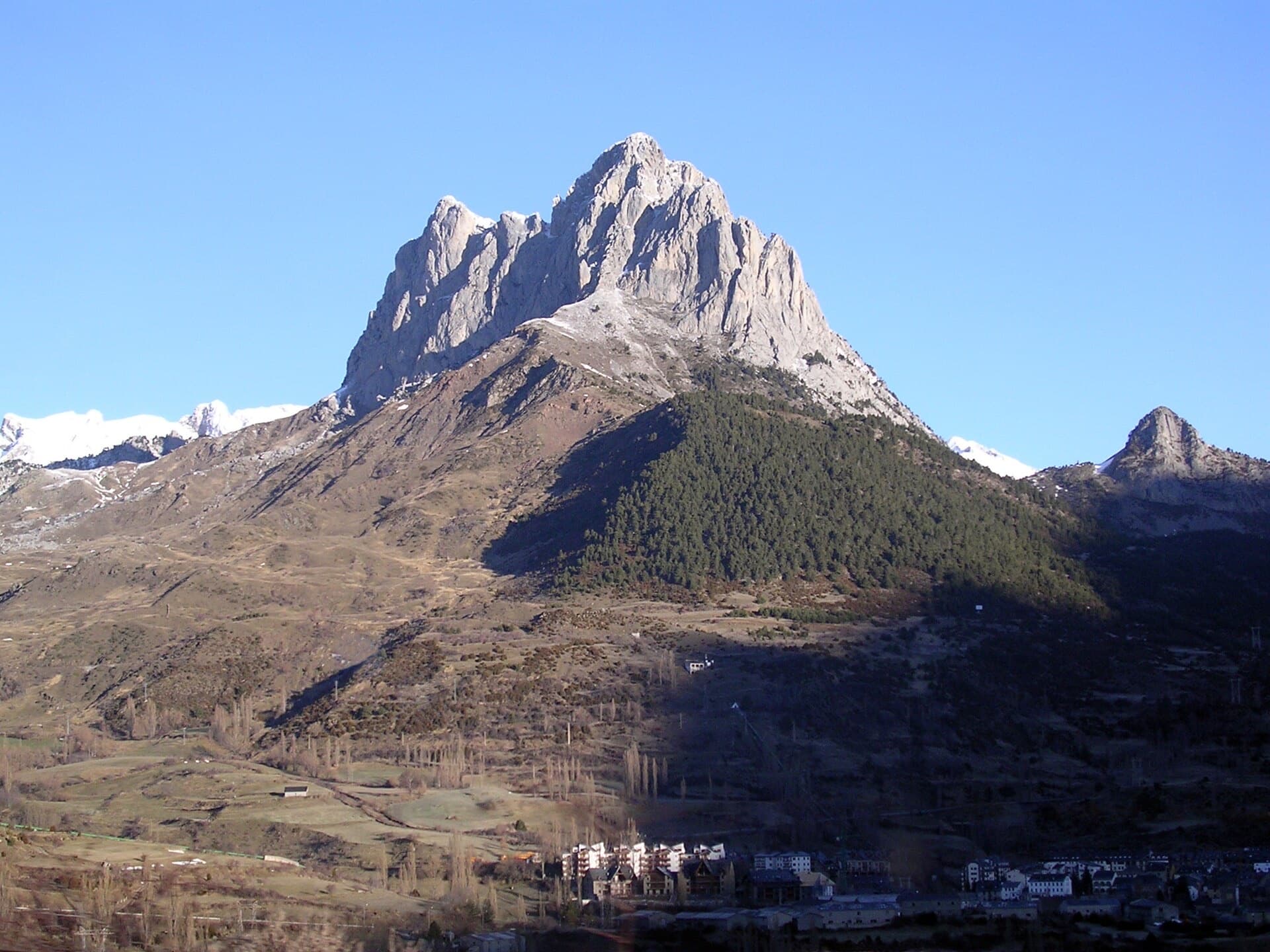 The limestone south face of the Peña Foratata rising above Sallent de Gállego in the Tena valley. Vía Anzas climbs this side of the peak; the exact line cannot be picked out here.