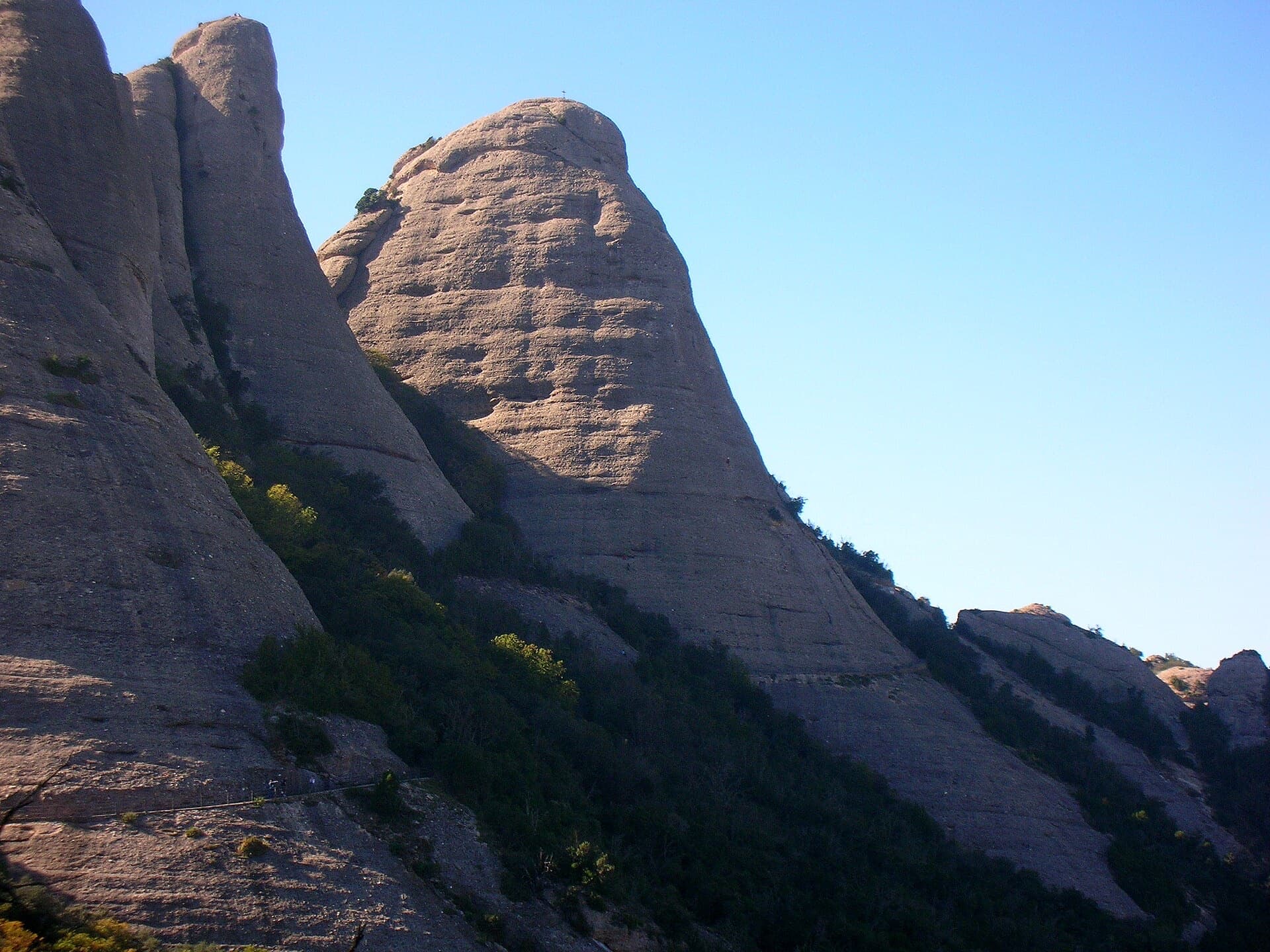 The Gorra Frígia seen from the Camí Nou de Sant Jeroni on the northern side of the Gorros, Montserrat. Via Stromberg climbs the north face; the line is not marked.
