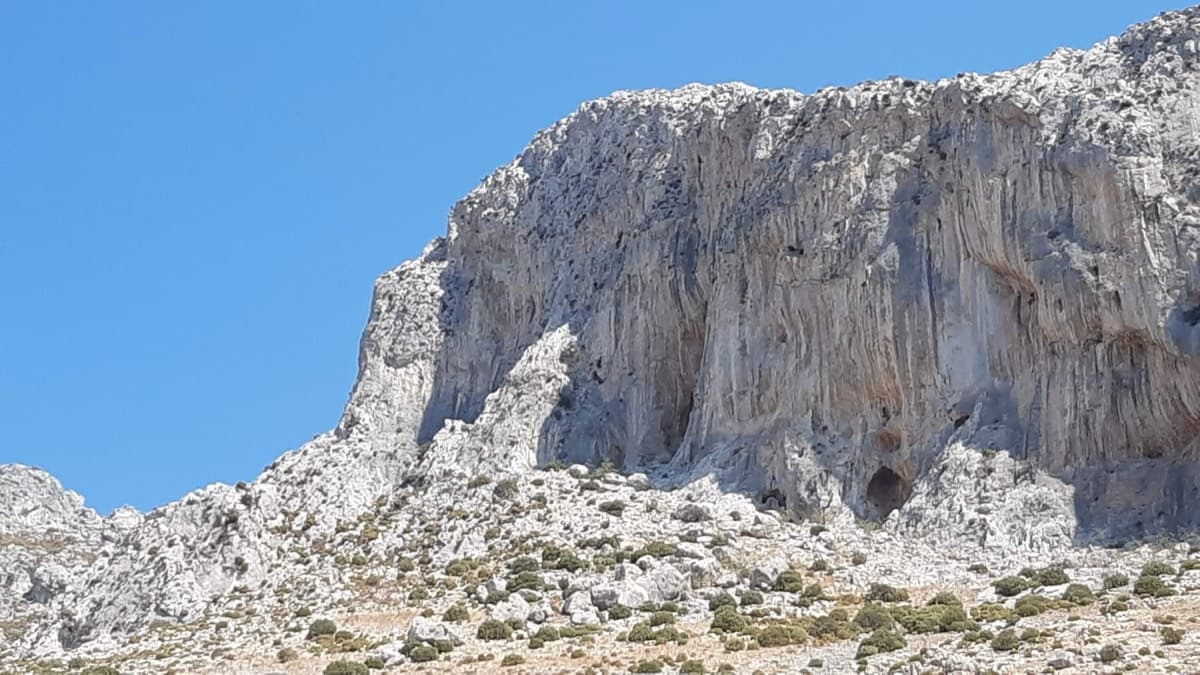 The cliff above the Grande Grotta: 3 Stripes starts on the second-to-last spur on the left and finishes up the shaded wall